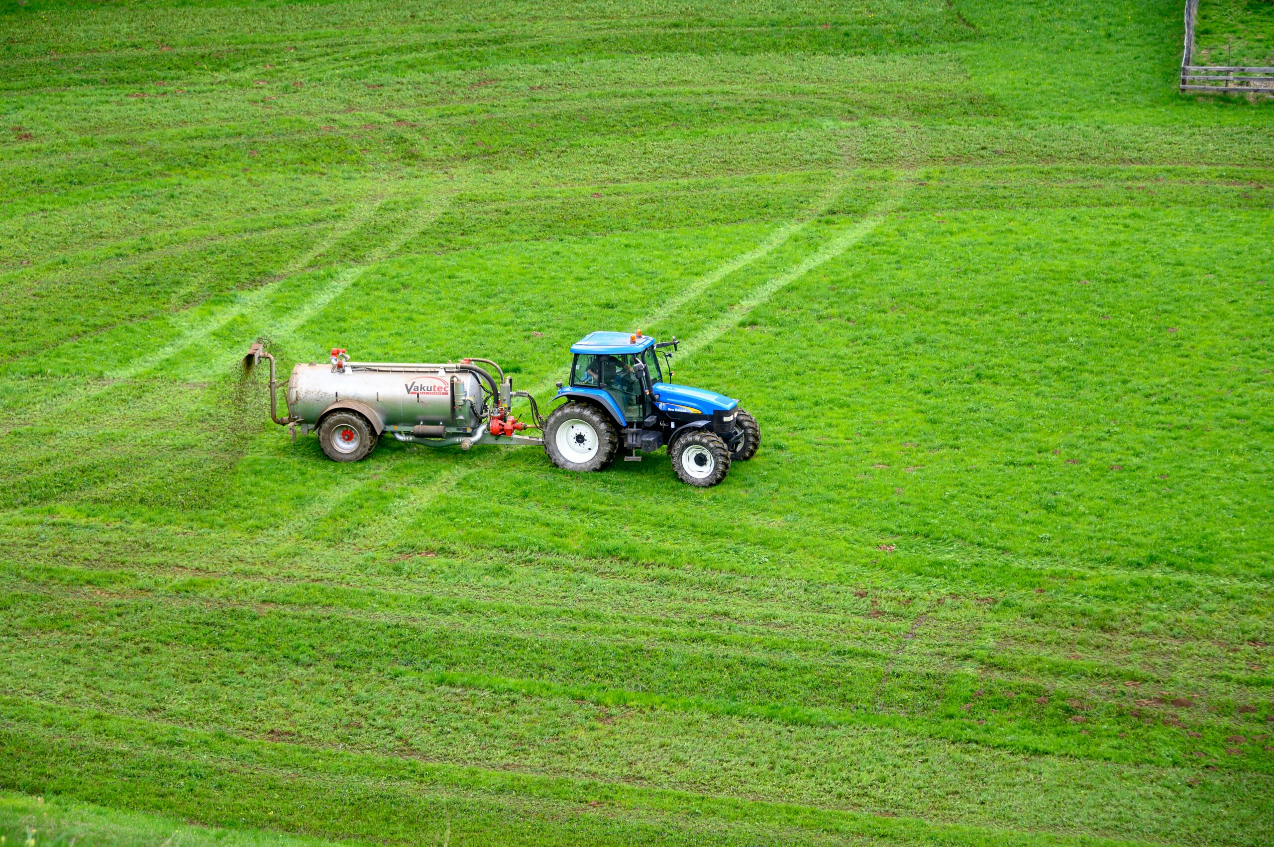 Fertilizer treatment being applied to a lawn